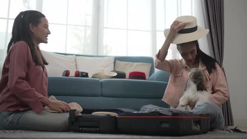 Friends Packing Suitcase for Travel with Dog