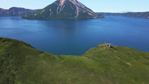 AERIAL Helicopter Standing on the Edge of Krenitsyn Volcano