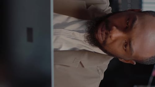 Man Working at Computer in Office, Drinking Coffee