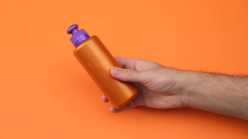 man holding skin cream