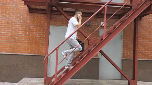 Businessman Climbing Up the Stairs of a Business Centre