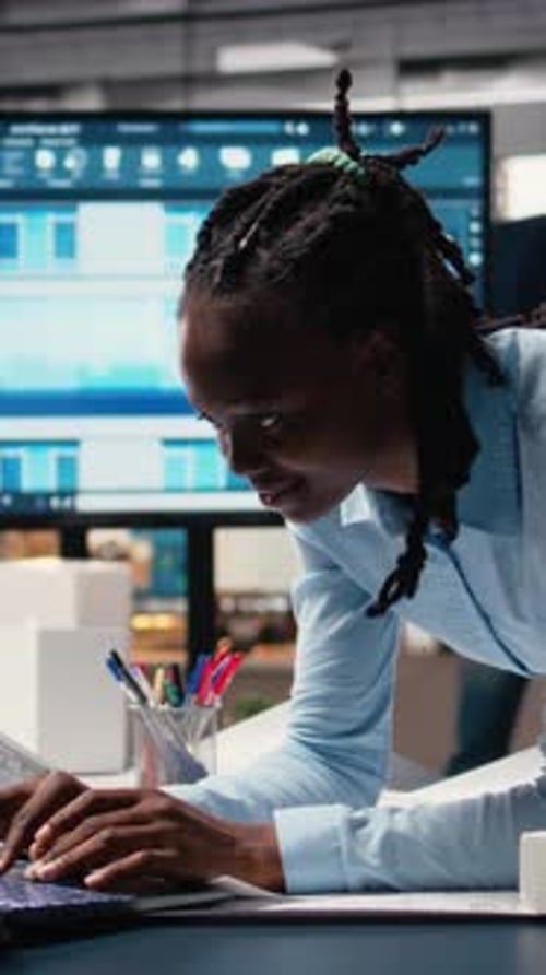 Vertical Video Real Estate Staff Member Evaluating Architectural Measurements on Blueprints