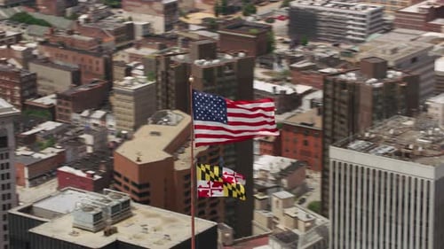 Aerial View of Baltimore City with USA and Maryland Flags