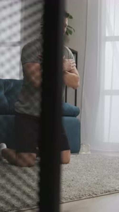 Man Performing Mindful Bodyweight Exercise on Knees in Calm Living Room Focusing on Posture
