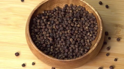 Black Peppercorns in Wooden Bowl, Overhead Shot