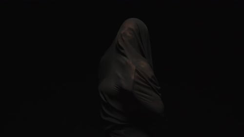 Figure Moving Under Thin Fabric in the Dark