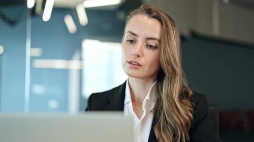 Professional Businesswoman Working on Laptop in Office