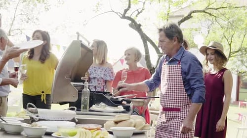 Family barbecue party celebration with food fun and laughter in the summer garden