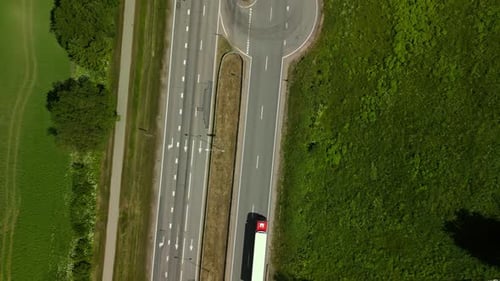 Aerial View of Highway Traffic in Countryside with Greenery and Trucks Creating Scenic Landscape for