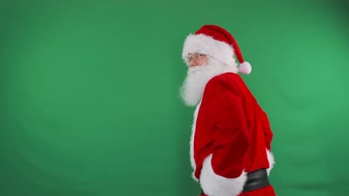 Santa Points to a Button on a Green Screen Perfect for Interactive Promotions