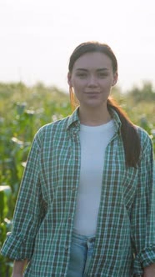Woman Standing Smiling in a Corn Field