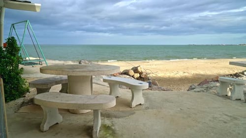 empty patio outdoor table and chair on beach with sea beach background