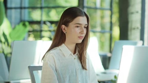 Confident Woman Working at Office Desk