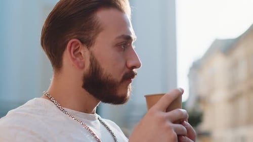 Young Man Guy Enjoying Drinking Morning Coffee Hot Drink Relaxing Taking a Break in City Street