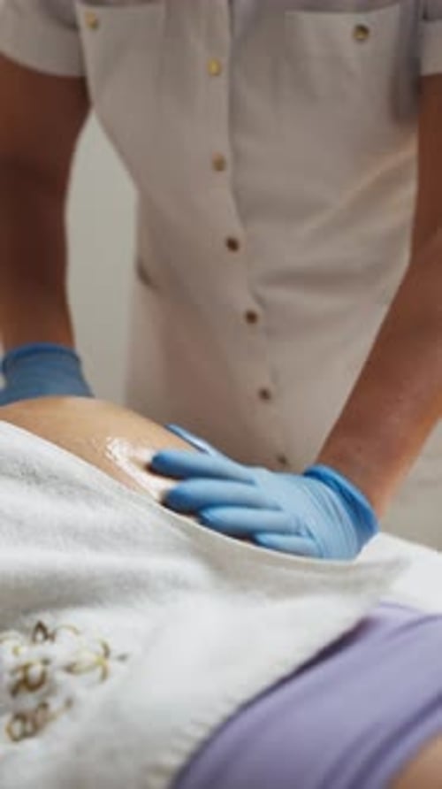 A Masseuse Giving a Shoulder Massage to a Client in a Spa - Close Up