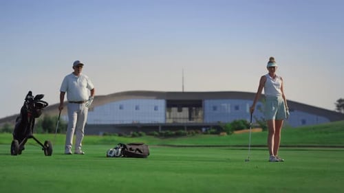Luxury golfers enjoy game on lush green fairway at sunny golf course