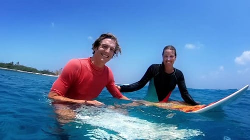Smiling Surfers on Surfboard Enjoy Tropical Blue Ocean