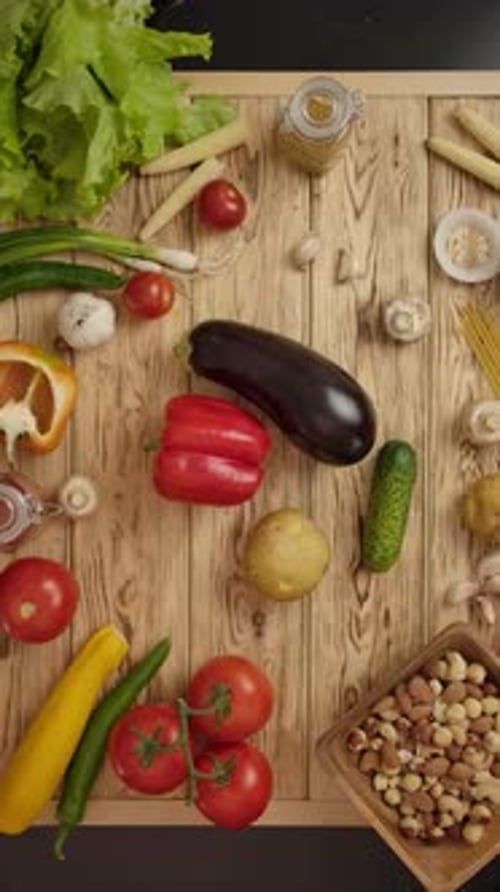 Vertical of People Taking Simultaneously Vegetables From Table