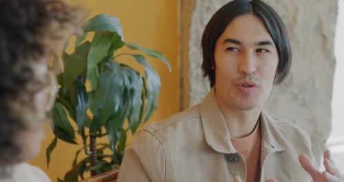 Young Adult Man Talking and Smiling Indoors