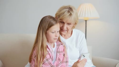Girl Teaches Grandmother How to Use Smartphone
