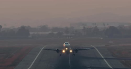 Airplane Takes Off at Sunrise or Sunset