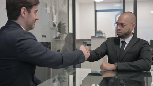 Businessmen Handshake in Modern Office