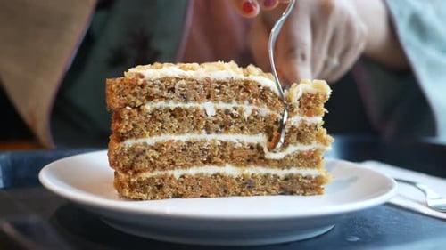 Person Use Fork Eating a Caramel Cake on Cafe