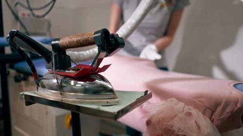 Woman Presses Garment With Professional Iron