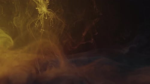 Yellow paint ink underwater falling to bottom - smoke and clouds swirls