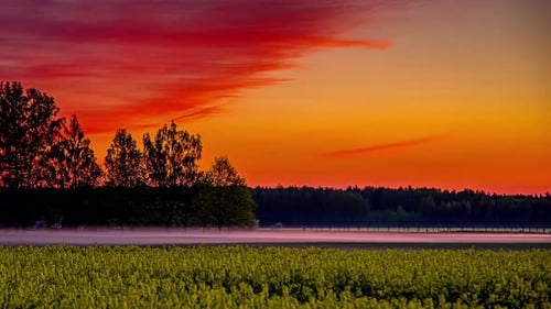 Fiery Red Sky Over Flowing River At Sunset. time lapse