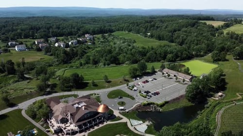 Drone backward movement, aerial view of a banquet house for celebrations and weddings, surrounded by