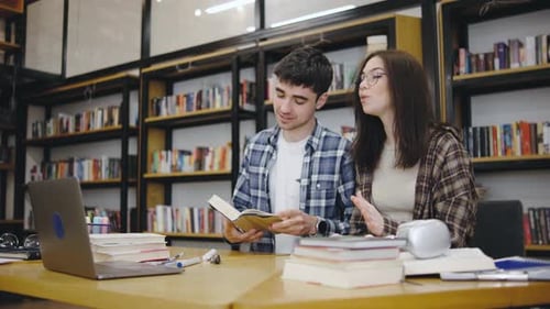 Students Engaged in Discussion While Studying Together in a Library Setting During the Afternoon