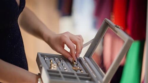 Stylish Woman Adorns Herself with Golden Earrings
