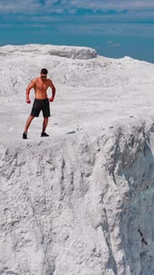 Muscular Man Exercising Outdoors in Unique Landscape