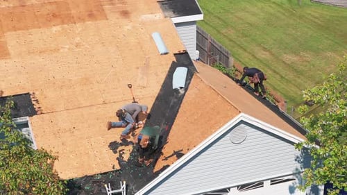 Element of Roofers Installing a New Roof on an Building Drone Shot
