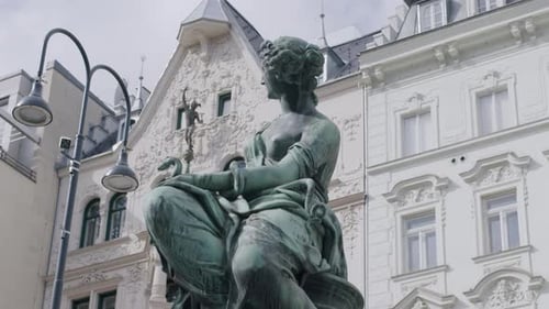 Historic Vienna fountain statue in Donnerbrunnen square with ornate architectural details
