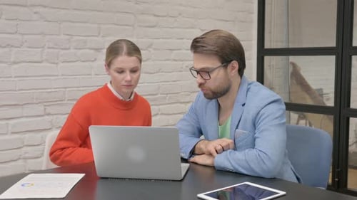 Business People Discussing Project while Sitting in Office