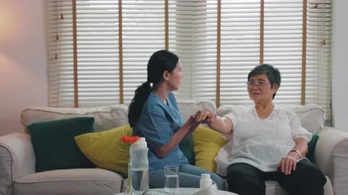 nurse provides physical therapy to the elderly at a nursing home