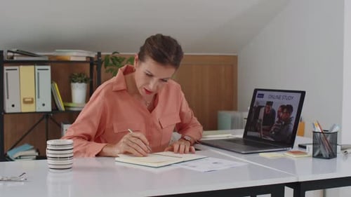 Woman Studies with Online Video at Home Office