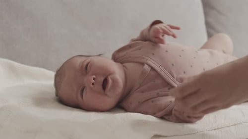 Comforting Infant on Blanket Inside Home