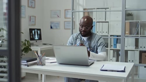 Doctor Telehealth Consultation on Laptop in Office