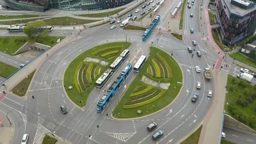 Aerial drone shot over Grunwaldzkie roundabout in Krakow, Poland with heavy traffic movement at dayt