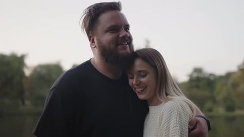 Couple Embracing Lovingly By a Picturesque Lake at Dusk
