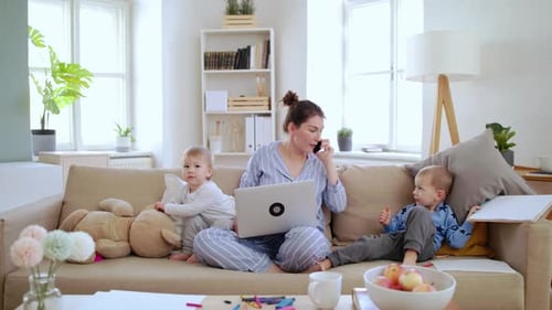 Mother with Small Children Working in Home Office Quarantine Concept