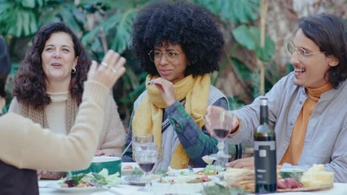 Friends Enjoying Lunch Together at Outdoor Garden Table