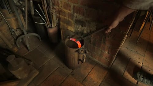 Blacksmith Quenching Glowing Horseshoe in Water