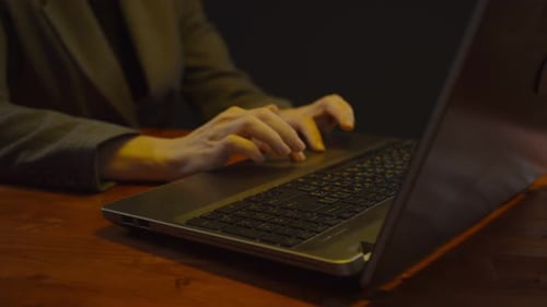 Typing on Laptop Keyboard in Dark Office