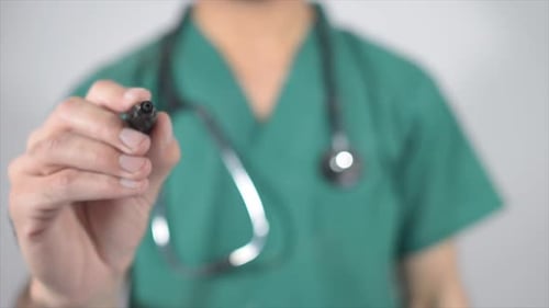 Doctor Writes the Word Cancer on Glass