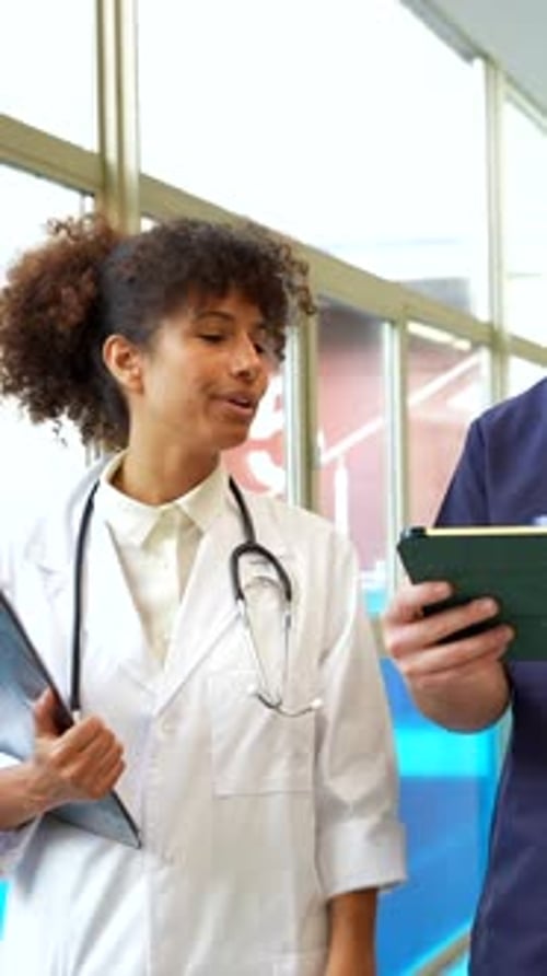 Medical Staff Walking Down Hospital Hallway