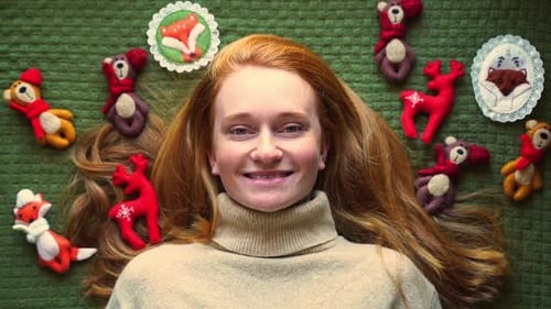 Woman with Red Hair Surrounded by Christmas Ornaments